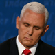 A fly rests on the head of US Vice President Mike Pence as he takes notes during the vice presidential debate against US Democratic vice presidential nominee and Senator from California Kamala Harris on October 7, 2020, in Salt Lake City, Utah.